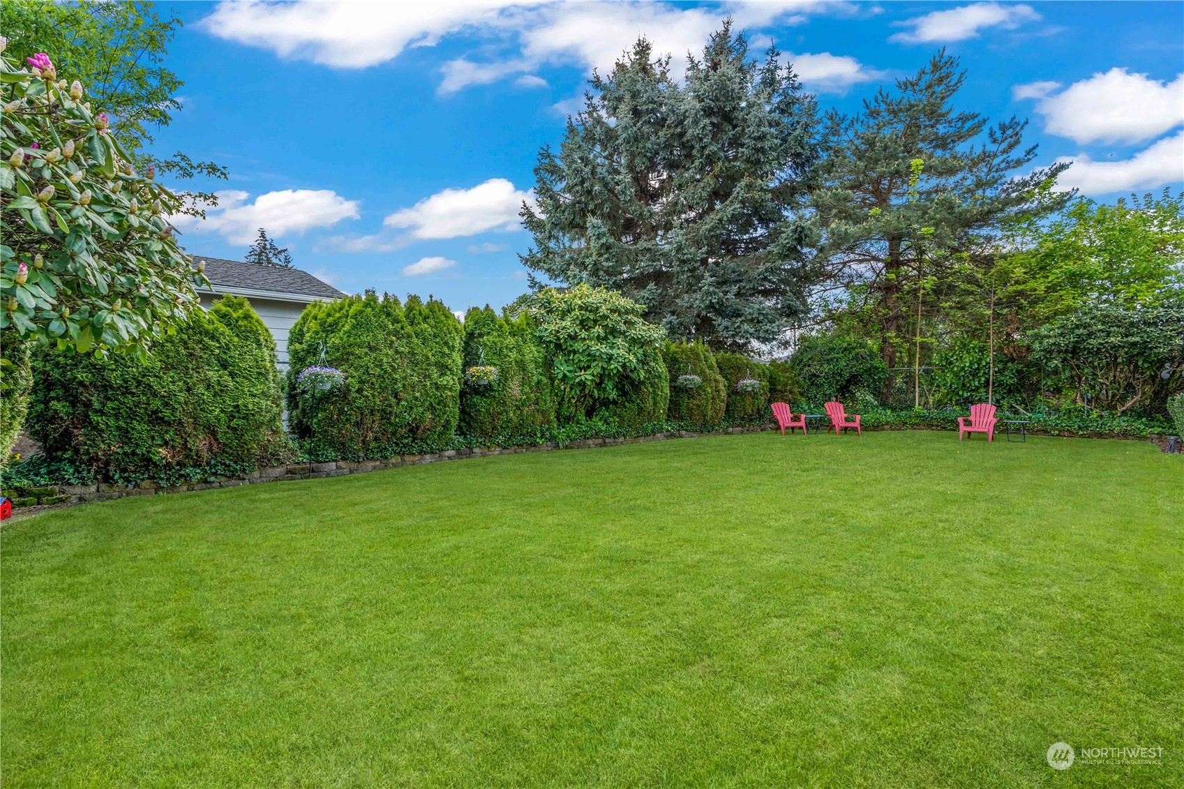 1616 Maple Street Sumner, WA 98390 - Photo 31 of 40 a view of yard with seating area and trees all around