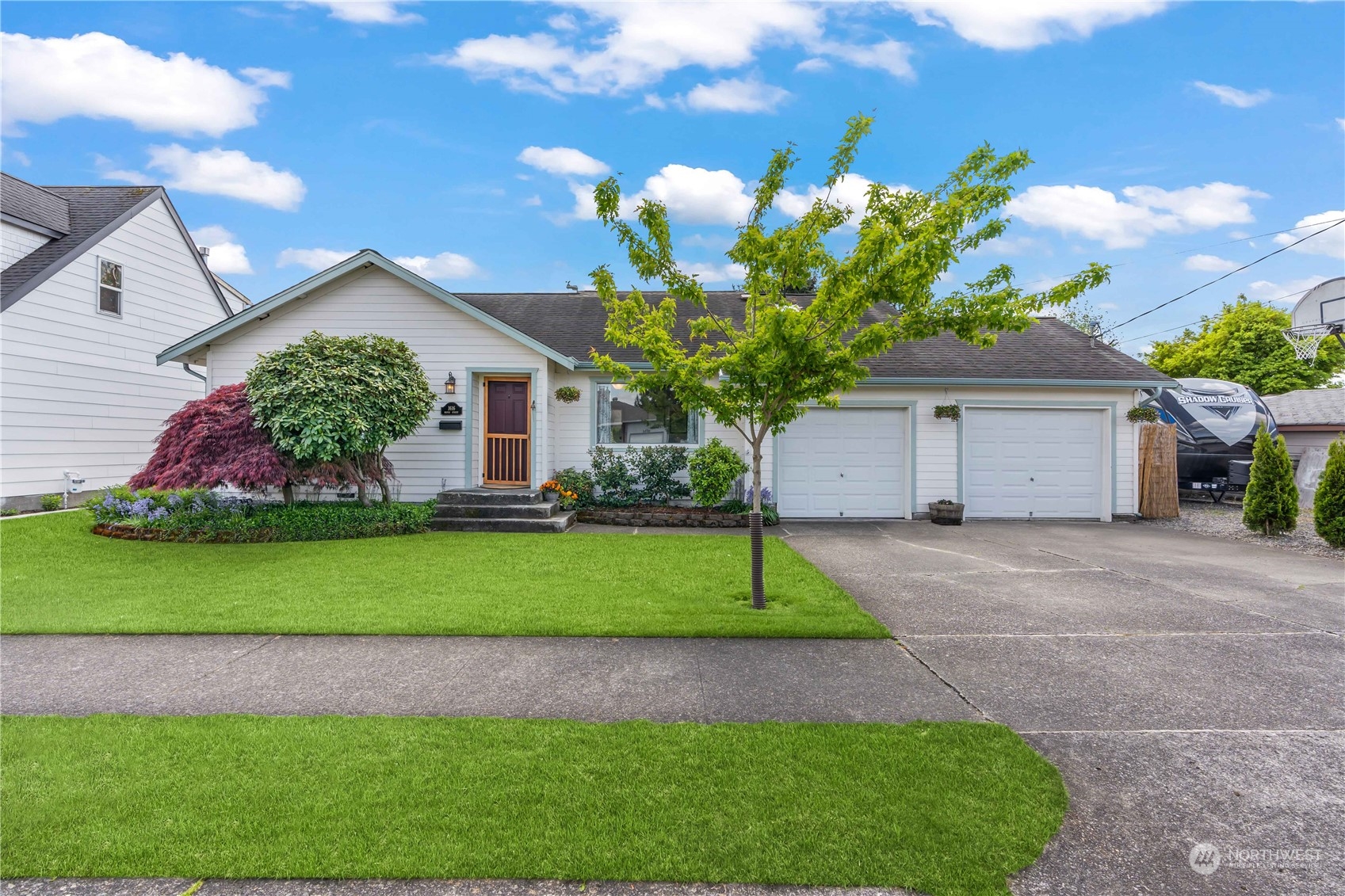 1616 Maple Street Sumner, WA 98390 - Photo 38 of 40 a front view of a house with a garden and trees
