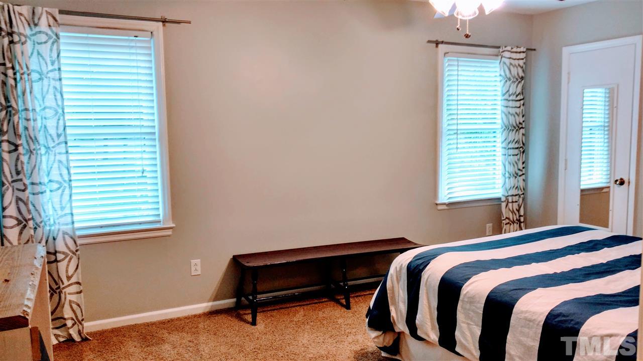 5517 Mapleridge Road Raleigh, NC 27609 - Photo 11 of 17 a bedroom with a bed and a window