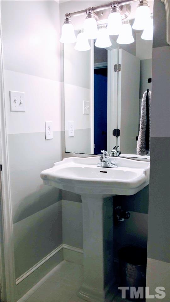 5517 Mapleridge Road Raleigh, NC 27609 - Photo 15 of 17 a bathroom with a sink and a mirror