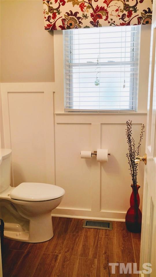 5517 Mapleridge Road Raleigh, NC 27609 - Photo 16 of 17 a bathroom with a toilet and a shower