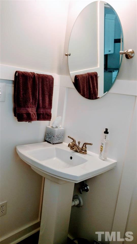 5517 Mapleridge Road Raleigh, NC 27609 - Photo 17 of 17 a bathroom with a sink and a mirror