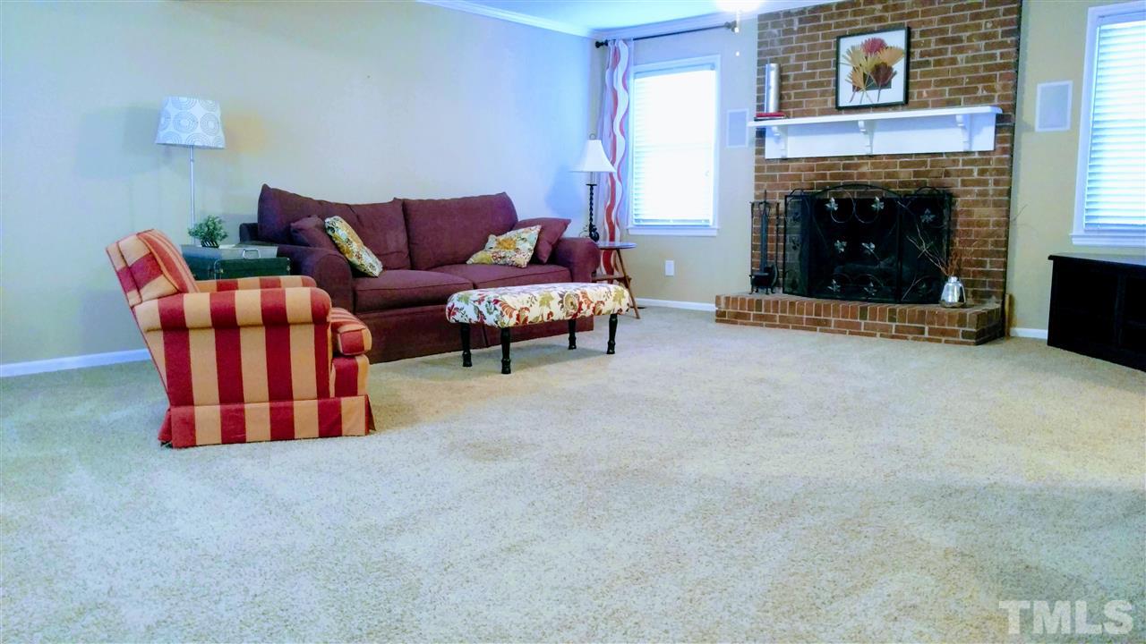 5517 Mapleridge Road Raleigh, NC 27609 - Photo 7 of 17 a living room with furniture and a fireplace