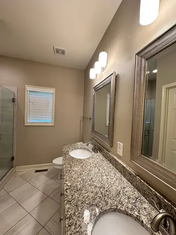 a bedroom with a bed and a mirror