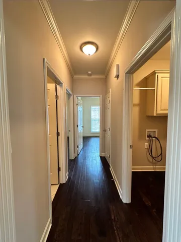 a view of a hallway with wooden floor