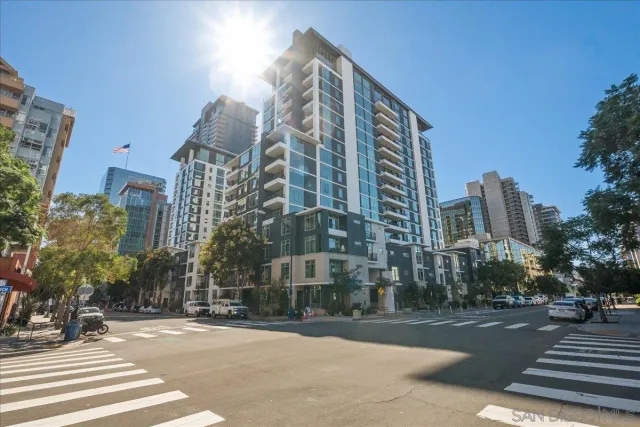 a view of a city street lined with buildings and trees