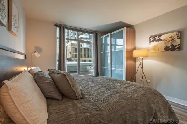 a bedroom with a bed and a night stand