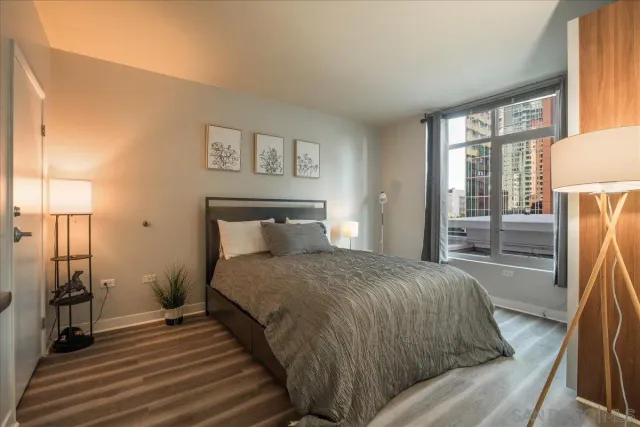 a bedroom with a bed and wooden floor