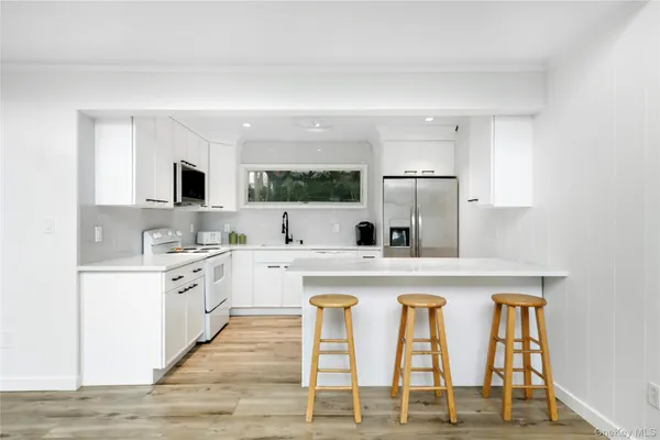 a kitchen with cabinets a sink and appliances
