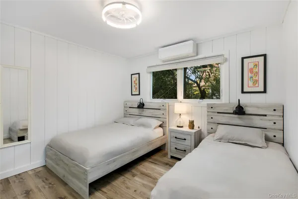 a bedroom with two beds and a large window