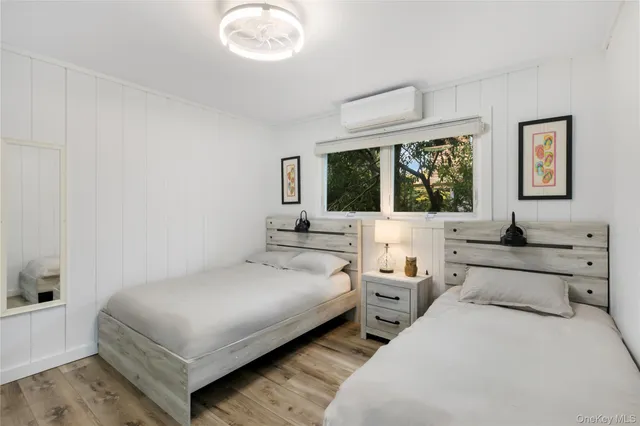 a bedroom with two beds and a large window