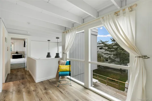 a bedroom with bed and a large window