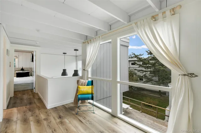 a bedroom with bed and a large window