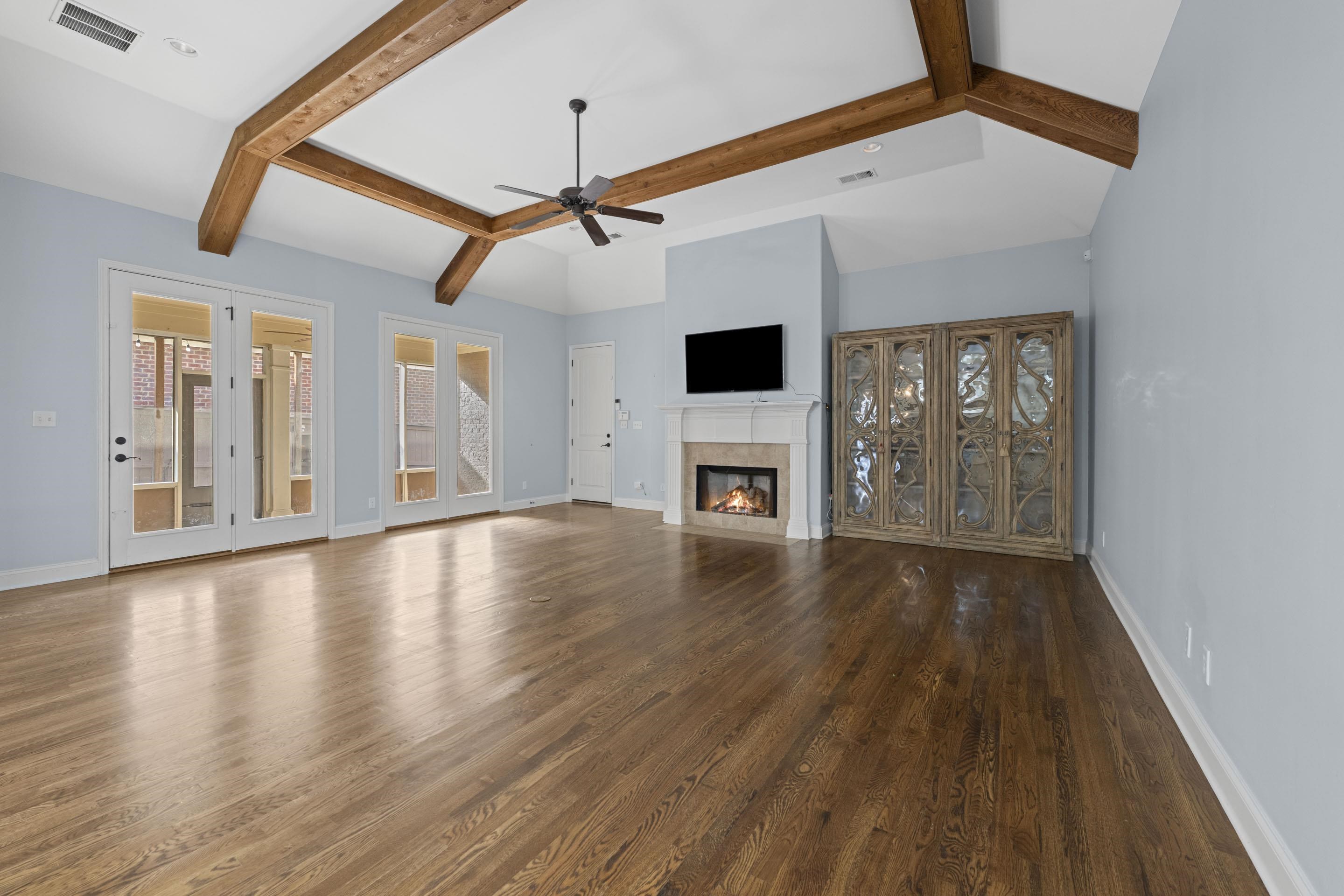 389 South Tarren Mill Circle Collierville, TN 38017 - Photo 11 of 32 a view of an empty room with wooden floor fireplace and a window