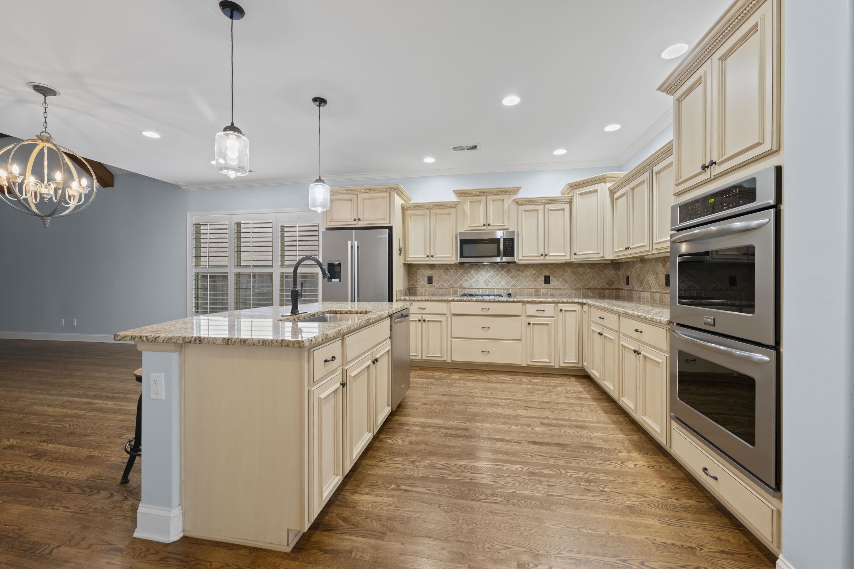 389 South Tarren Mill Circle Collierville, TN 38017 - Photo 12 of 32 a large kitchen with stainless steel appliances granite countertop a sink a stove top oven a counter space and cabinets