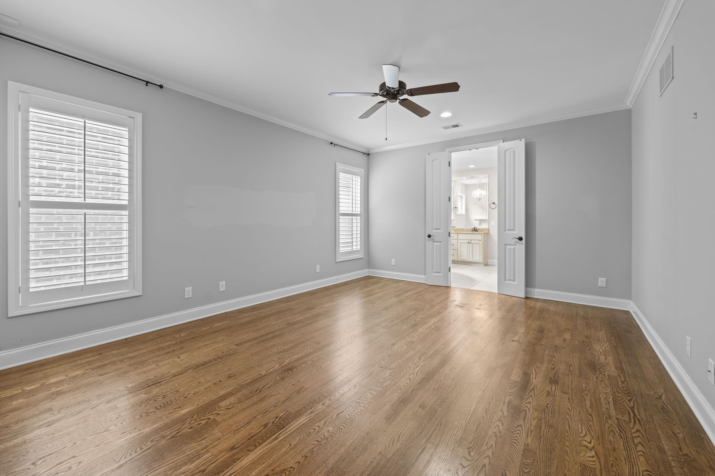 389 South Tarren Mill Circle Collierville, TN 38017 - Photo 17 of 32 a view of an empty room with wooden floor and a window
