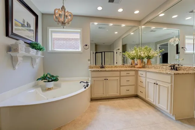 a bathroom with a bathtub sink and mirror