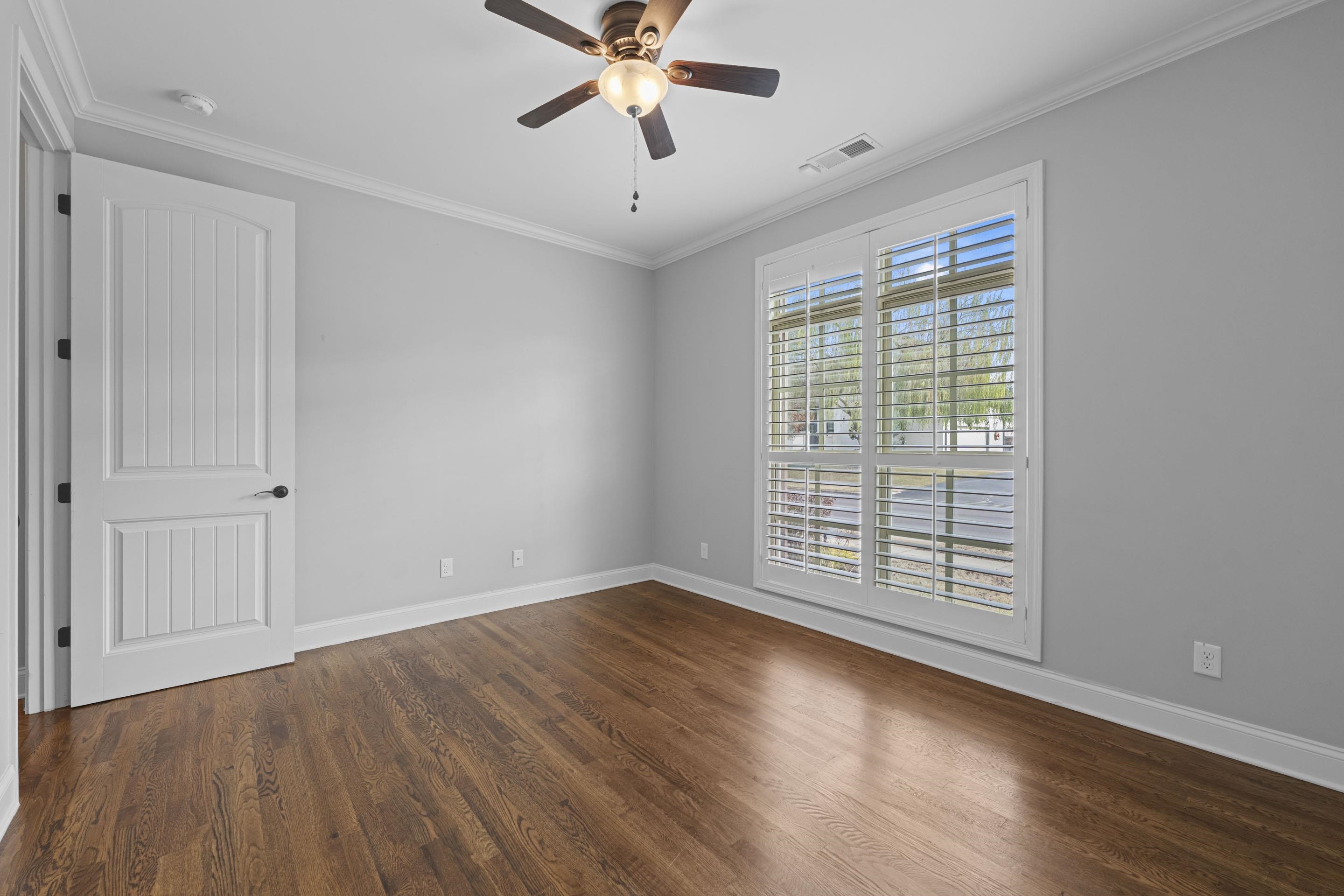 389 South Tarren Mill Circle Collierville, TN 38017 - Photo 22 of 32 a view of an empty room with wooden floor and a window