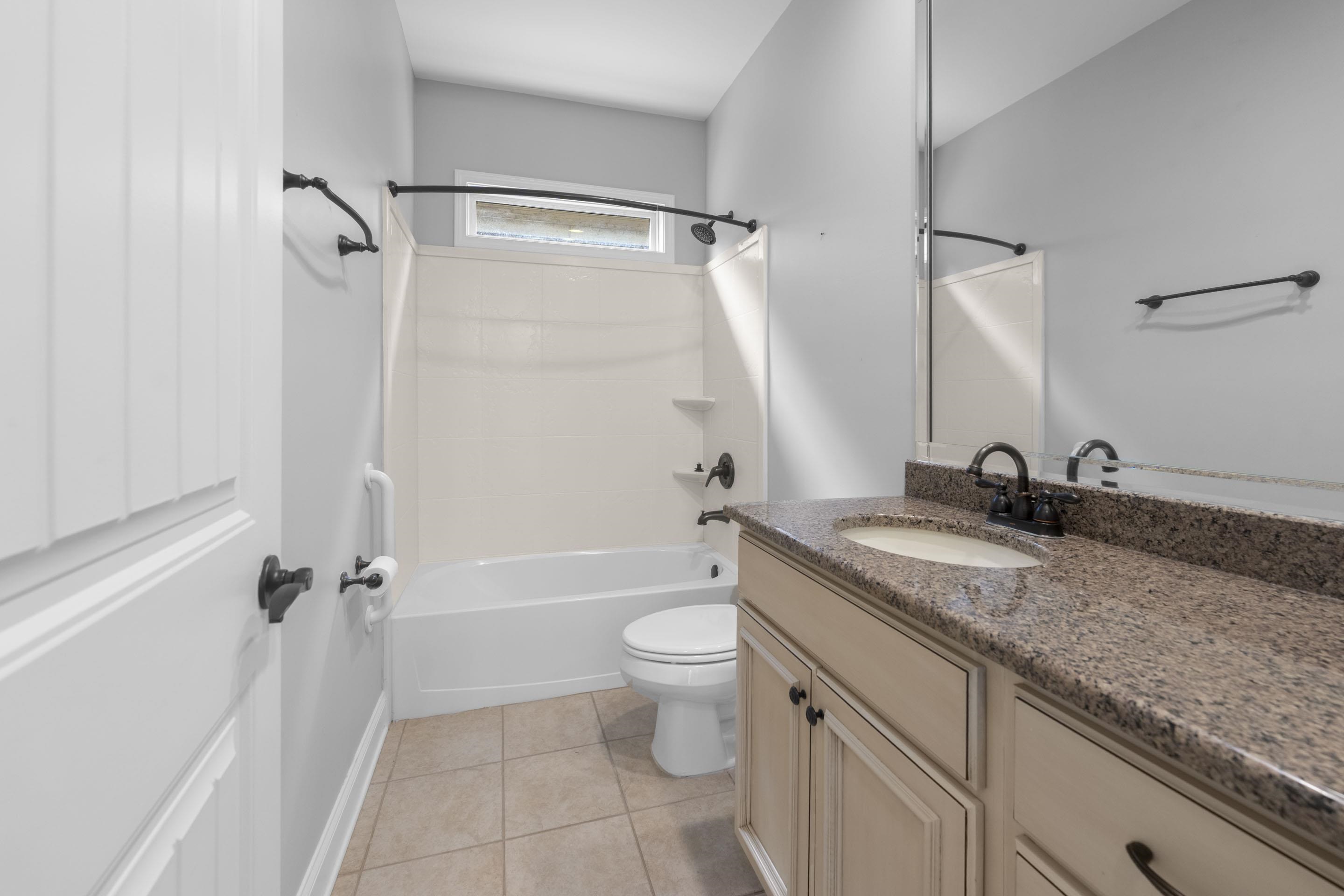 389 South Tarren Mill Circle Collierville, TN 38017 - Photo 25 of 32 a bathroom with a granite countertop sink a toilet and a bathtub