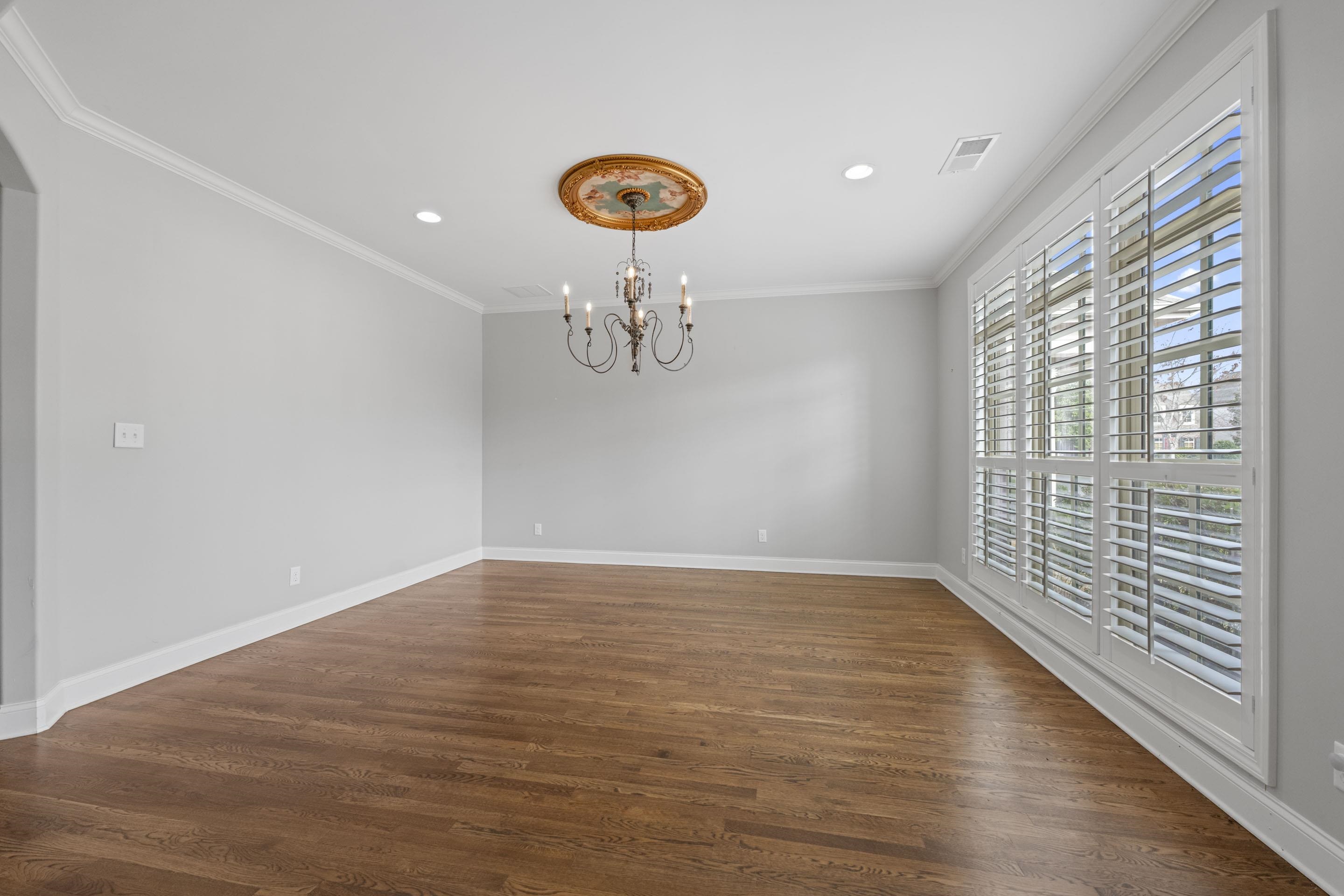 389 South Tarren Mill Circle Collierville, TN 38017 - Photo 7 of 32 a view of an empty room with window and wooden floor