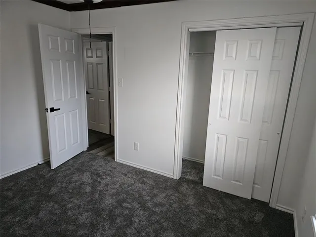 a view of an empty room with closet area