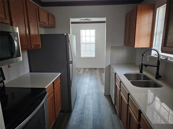 a kitchen with stainless steel appliances granite countertop a sink stove and refrigerator