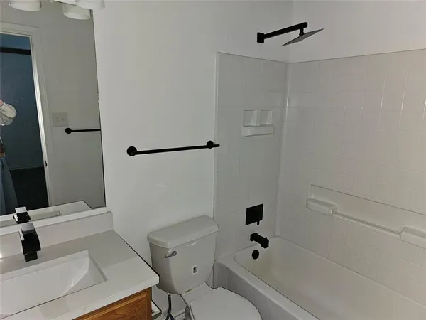 a bathroom with a bathtub and a toilet