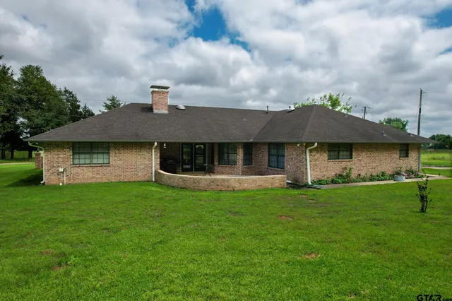a view of house with a yard