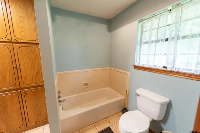 a spacious bathroom with a double vanity sink and a mirror