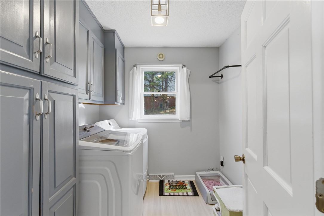 114 Halifax Road Easley, SC 29642 - Photo 12 of 32 Functional laundry room featuring abundant cabinet storage and a sunlit window for natural light.
