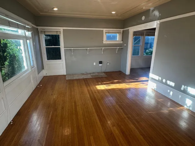 a view of room with window and wooden floor