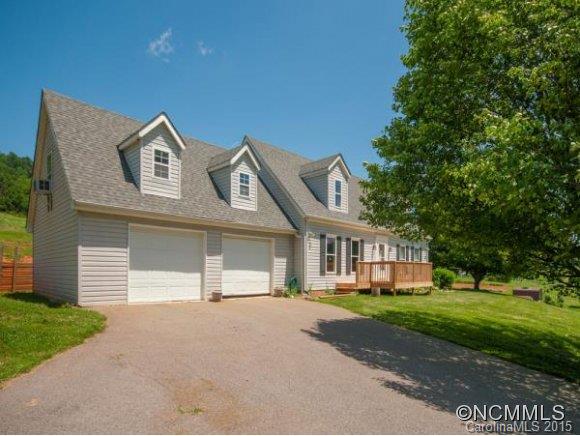 378 Yates Cove Road Waynesville, NC 28785 - Photo 2 of 17 a front view of a house with a garden