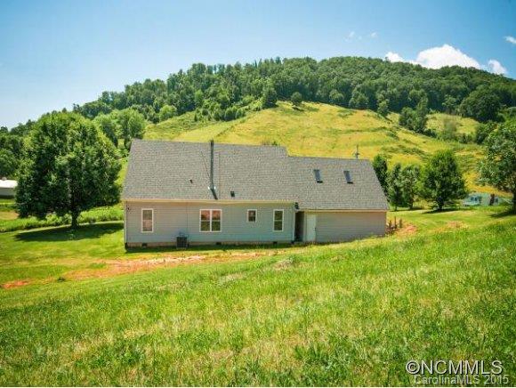 378 Yates Cove Road Waynesville, NC 28785 - Photo 14 of 17 a view of a house with a yard