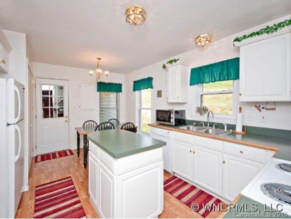 378 Yates Cove Road Waynesville, NC 28785 - Photo 4 of 17 a kitchen with a sink stove and cabinets