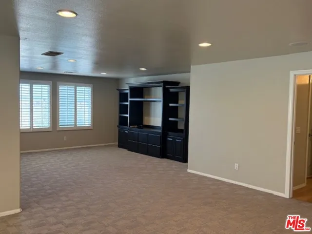 a view of livingroom and a kitchen with furniture