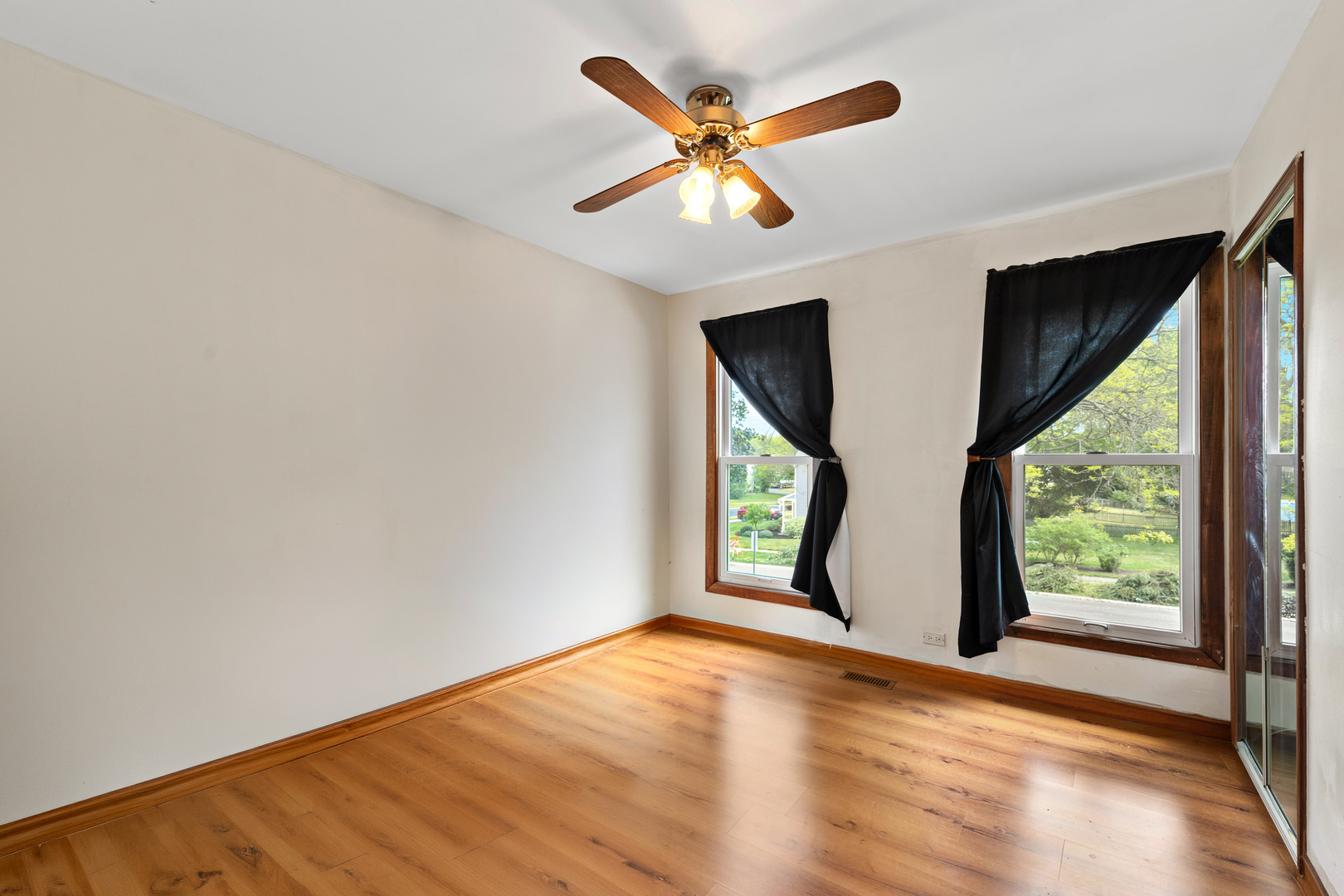 506 Old Hunt Road Fox River Grove, IL 60021 - Photo 23 of 44 an empty room with wooden floor and windows