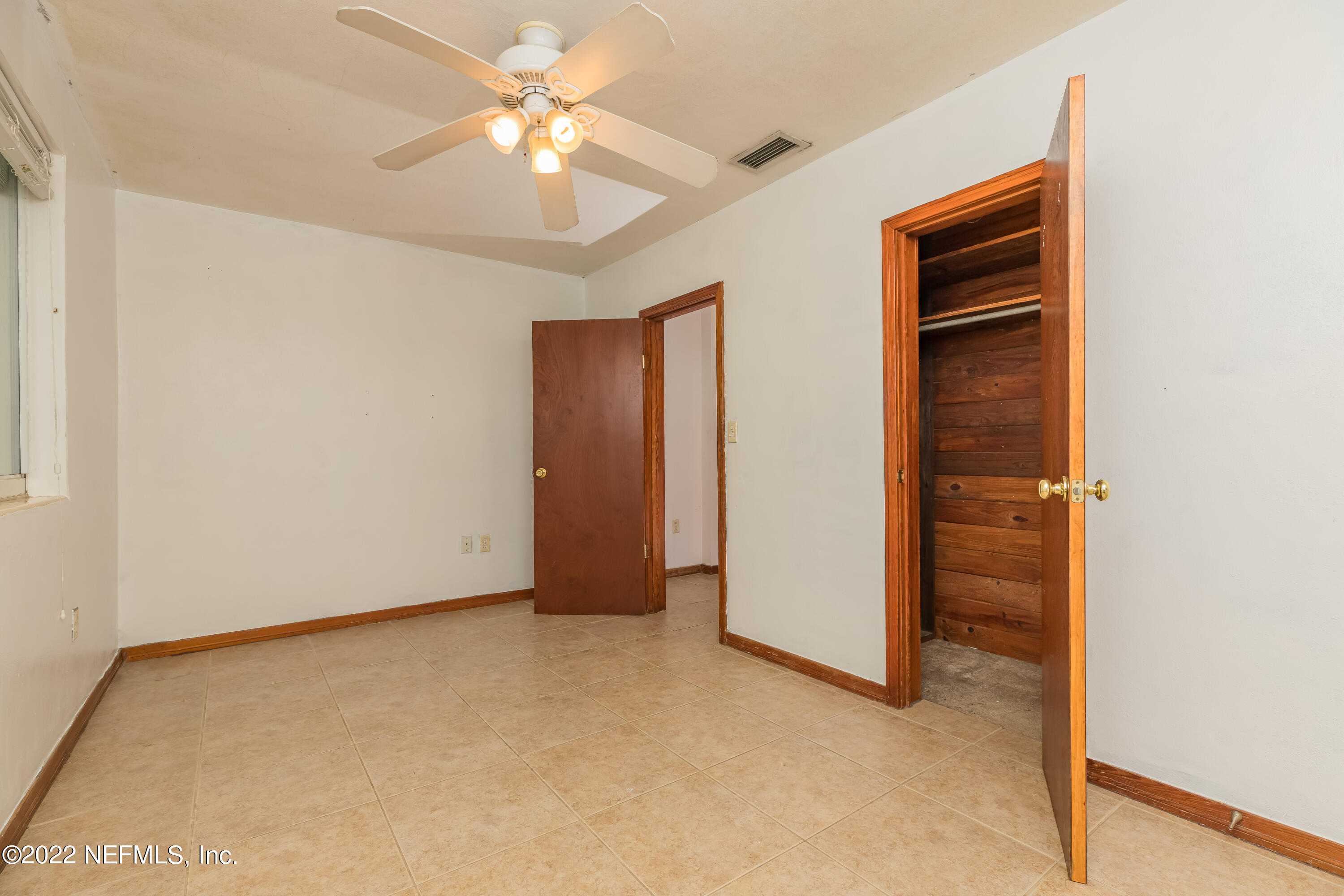 306 Ribault Street St. Augustine, FL 32080 - Photo 24 of 31 an empty room with a ceiling fan and a window
