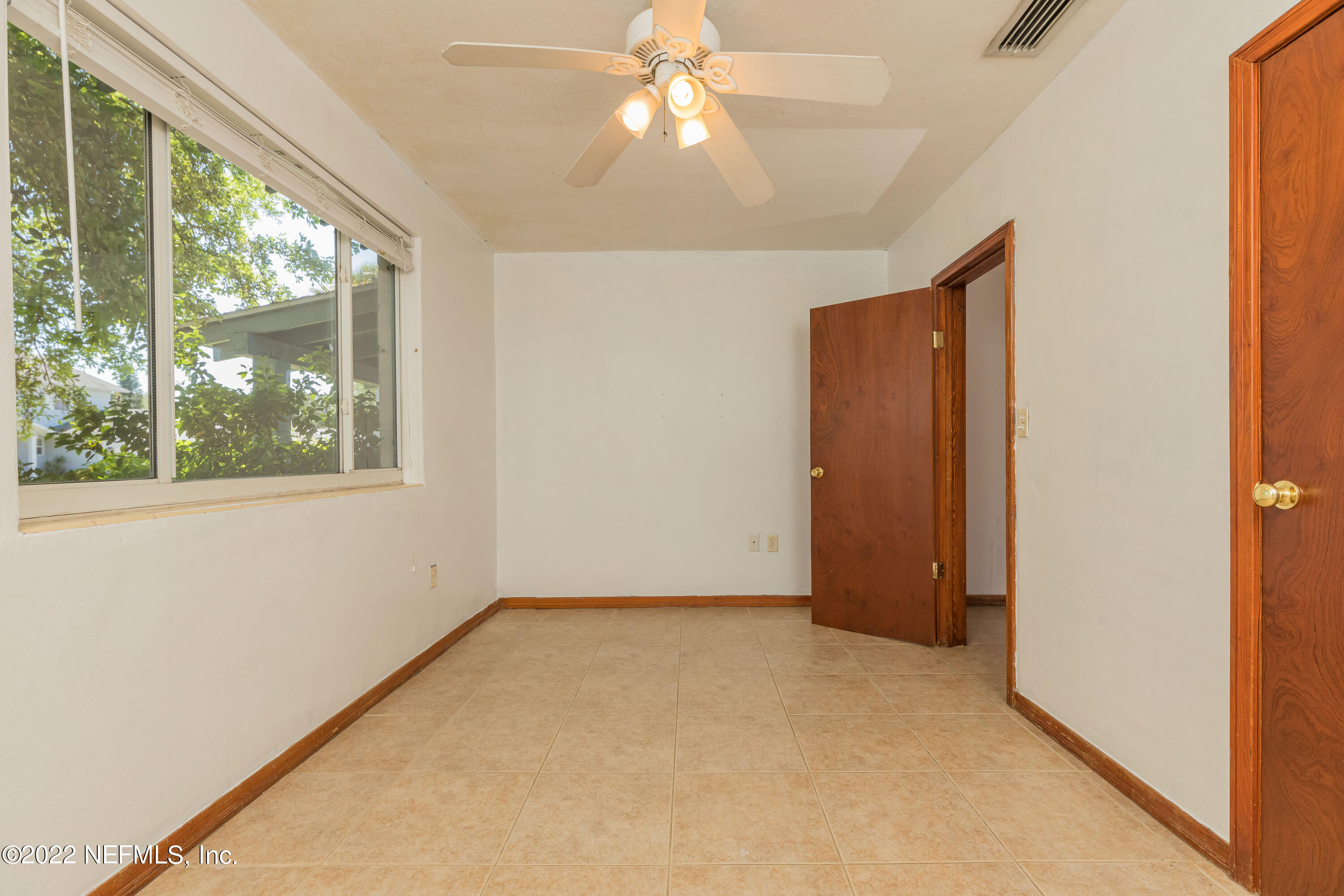 306 Ribault Street St. Augustine, FL 32080 - Photo 25 of 31 en empty room with windows and chandelier fan