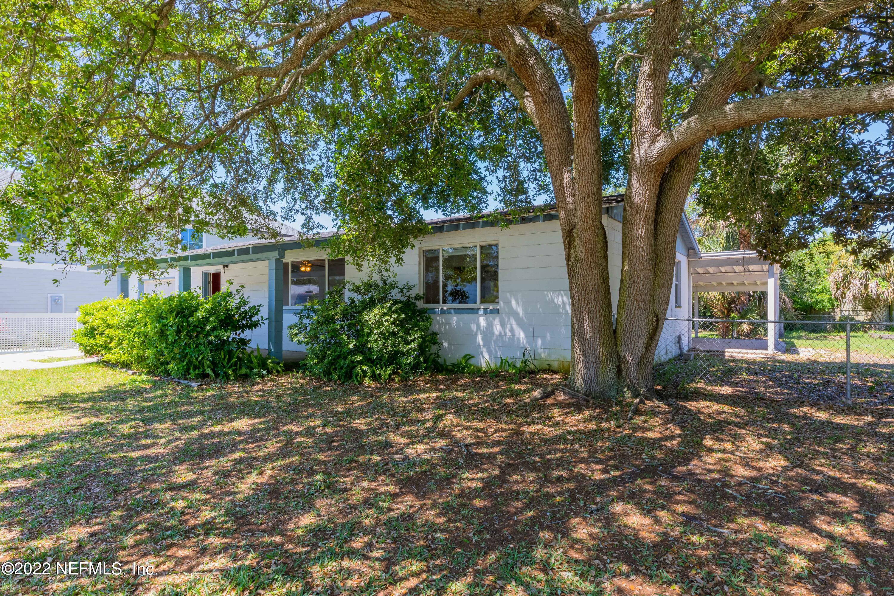 306 Ribault Street St. Augustine, FL 32080 - Photo 3 of 31 a backyard of a house with plants and large tree