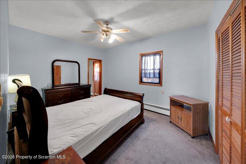 1228 Lake Road Factoryville, PA 18419 - Photo 29 of 43 a bedroom with a bed and a chandelier