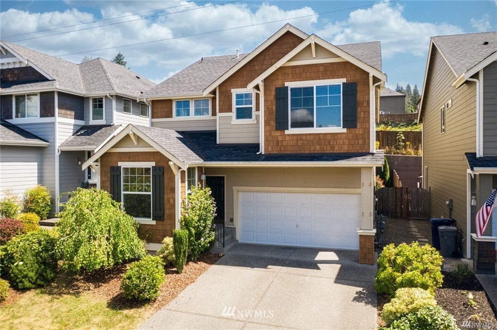 23007 42nd Drive Southeast Bothell, WA 98021 - Photo 1 of 29 a front view of a house with a yard and garage