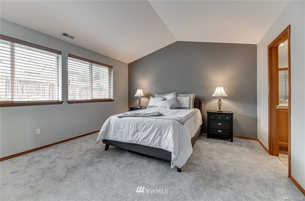23007 42nd Drive Southeast Bothell, WA 98021 - Photo 14 of 29 a spacious bedroom with a bed and a lamp