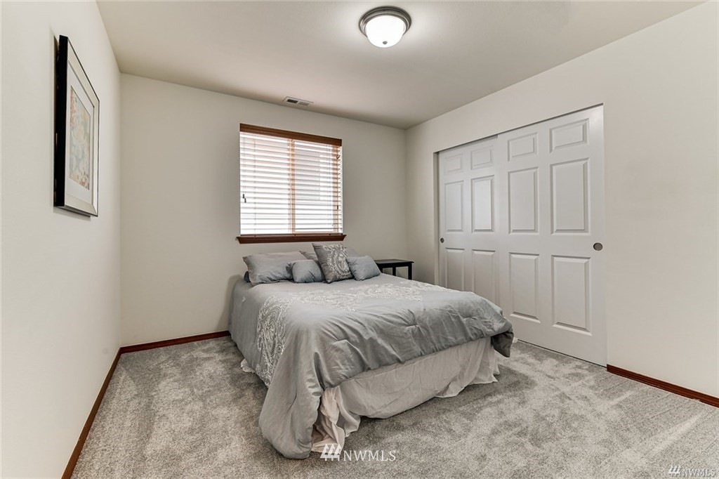 23007 42nd Drive Southeast Bothell, WA 98021 - Photo 21 of 29 a spacious bedroom with a bed and a window