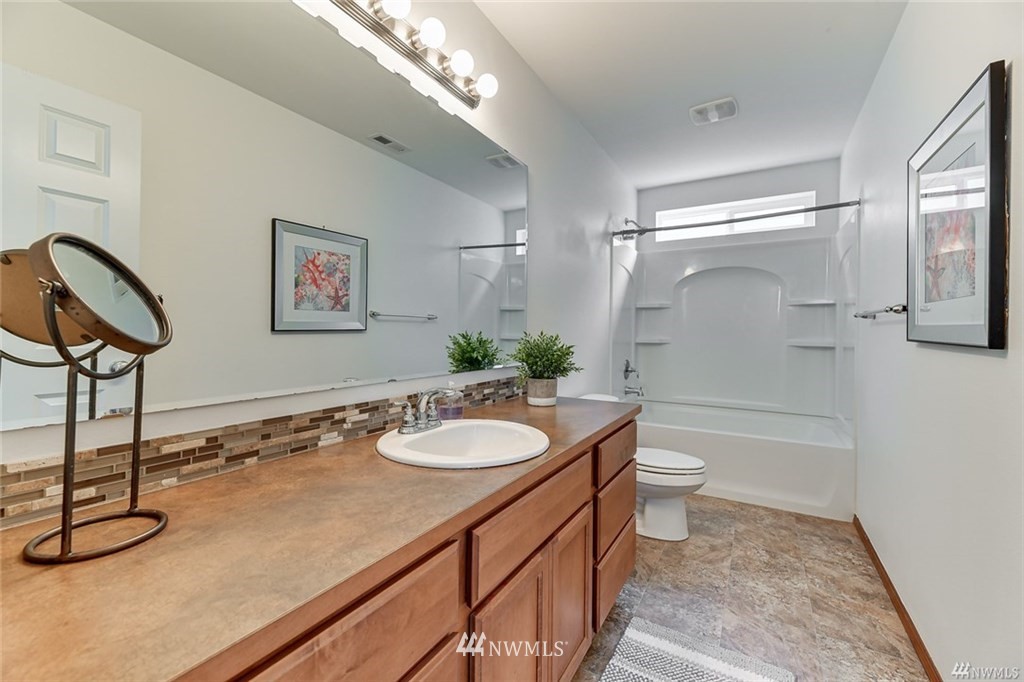 23007 42nd Drive Southeast Bothell, WA 98021 - Photo 25 of 29 a bathroom with a sink a toilet and a mirror