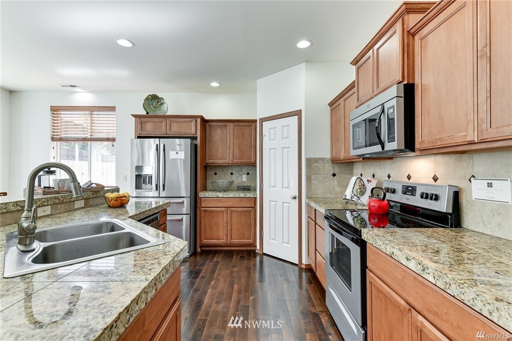 23007 42nd Drive Southeast Bothell, WA 98021 - Photo 5 of 29 a kitchen with stainless steel appliances granite countertop a sink stove and refrigerator