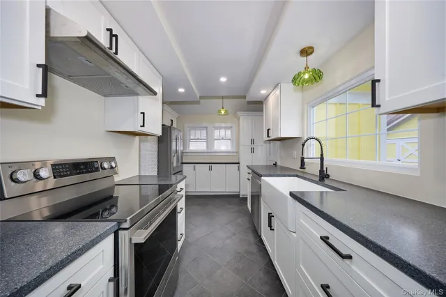 a kitchen with a sink stove and cabinets