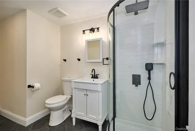 a bathroom with a granite countertop toilet sink and shower