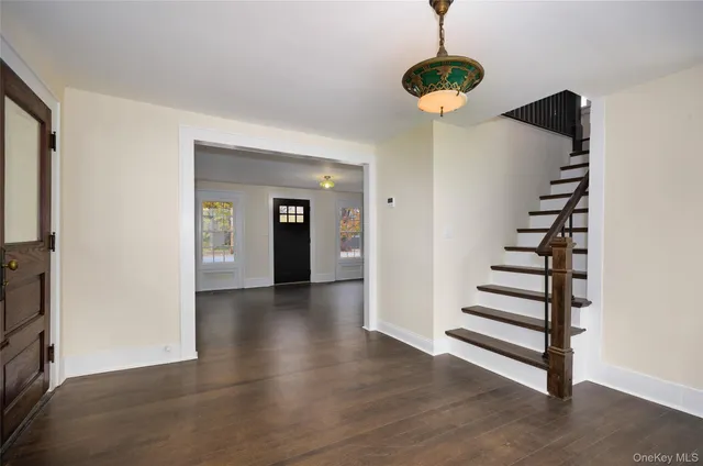 a view of a room with wooden floor and stairs