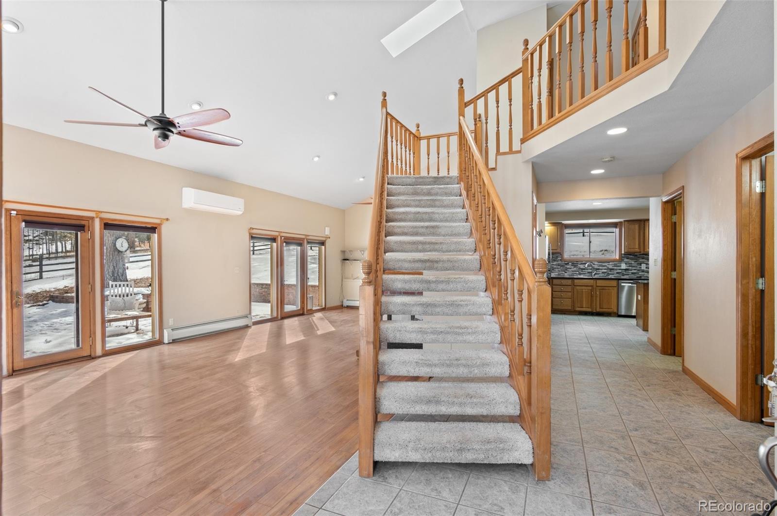 906 Conestoga Road Bailey, CO 80421 - Photo 5 of 49 a view of staircase with white walls and windows