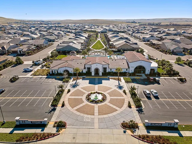 a living room with furniture a flat screen tv and a floor to ceiling window